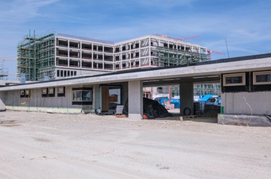 Sportbetriebsgebäude mit Gymnasium im Hintergrund