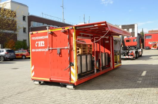 Abrollbehälter Sandsack