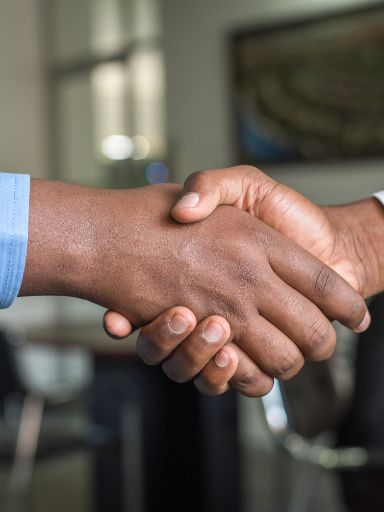 Zwei Menschen schütteln sich die Hände